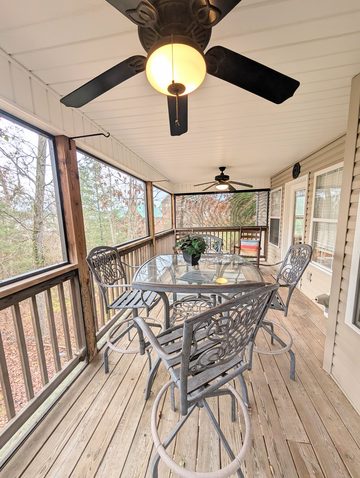 Screened back porch with patio table seating for four